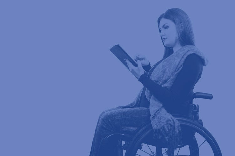 Woman in wheelchair holding tablet