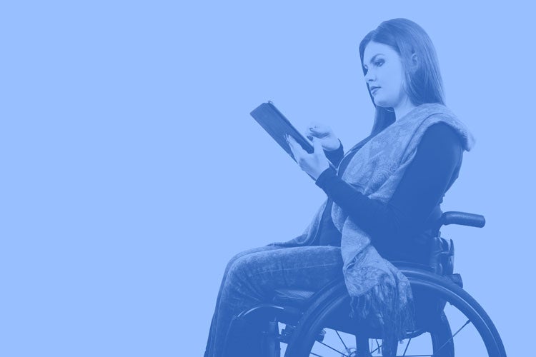 Woman in wheelchair holding tablet